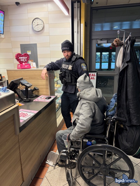 Boston Police Officer buying a community member coffee