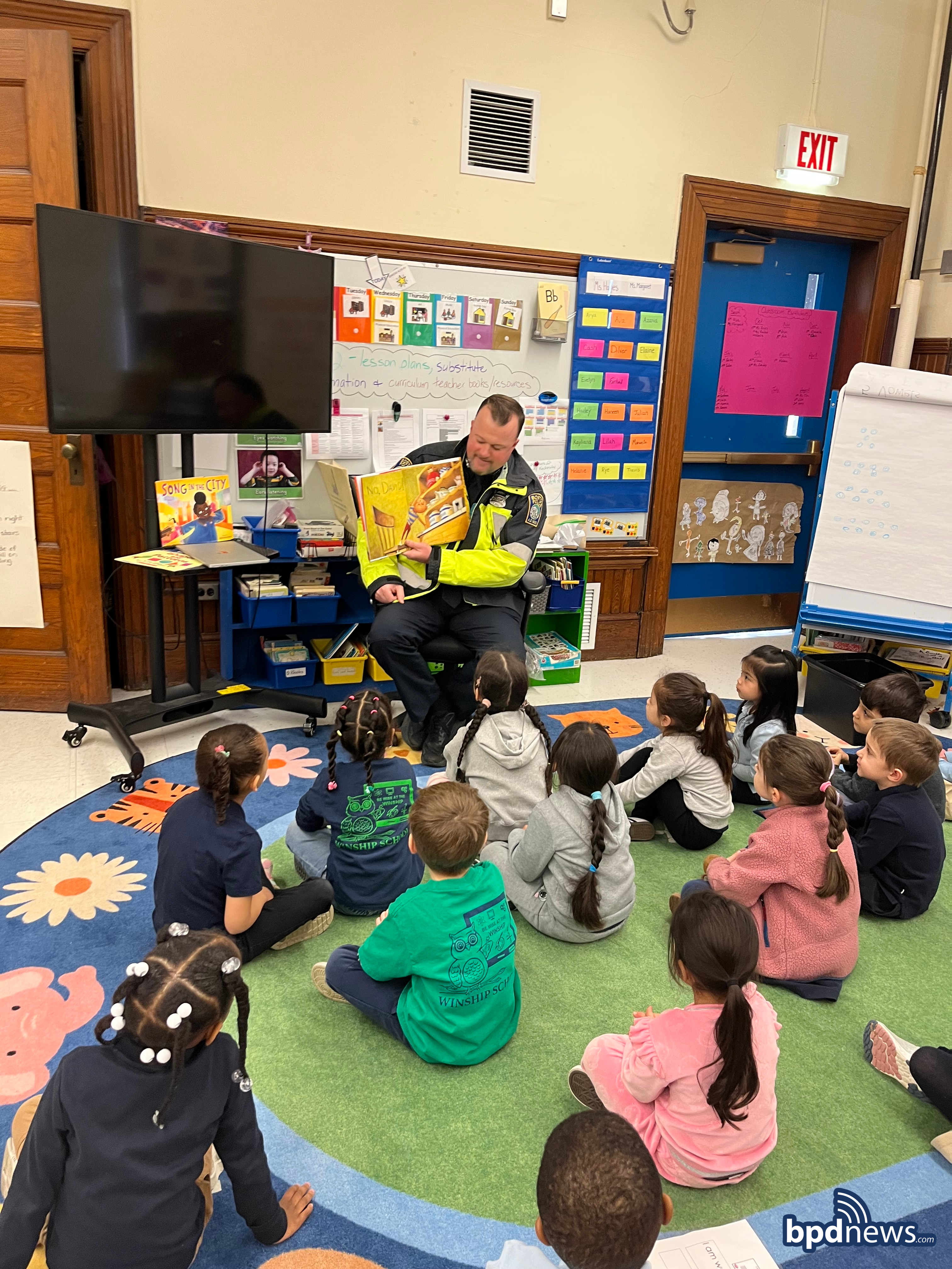 Officer from District D-14 reading to students at the Winship Elementary School