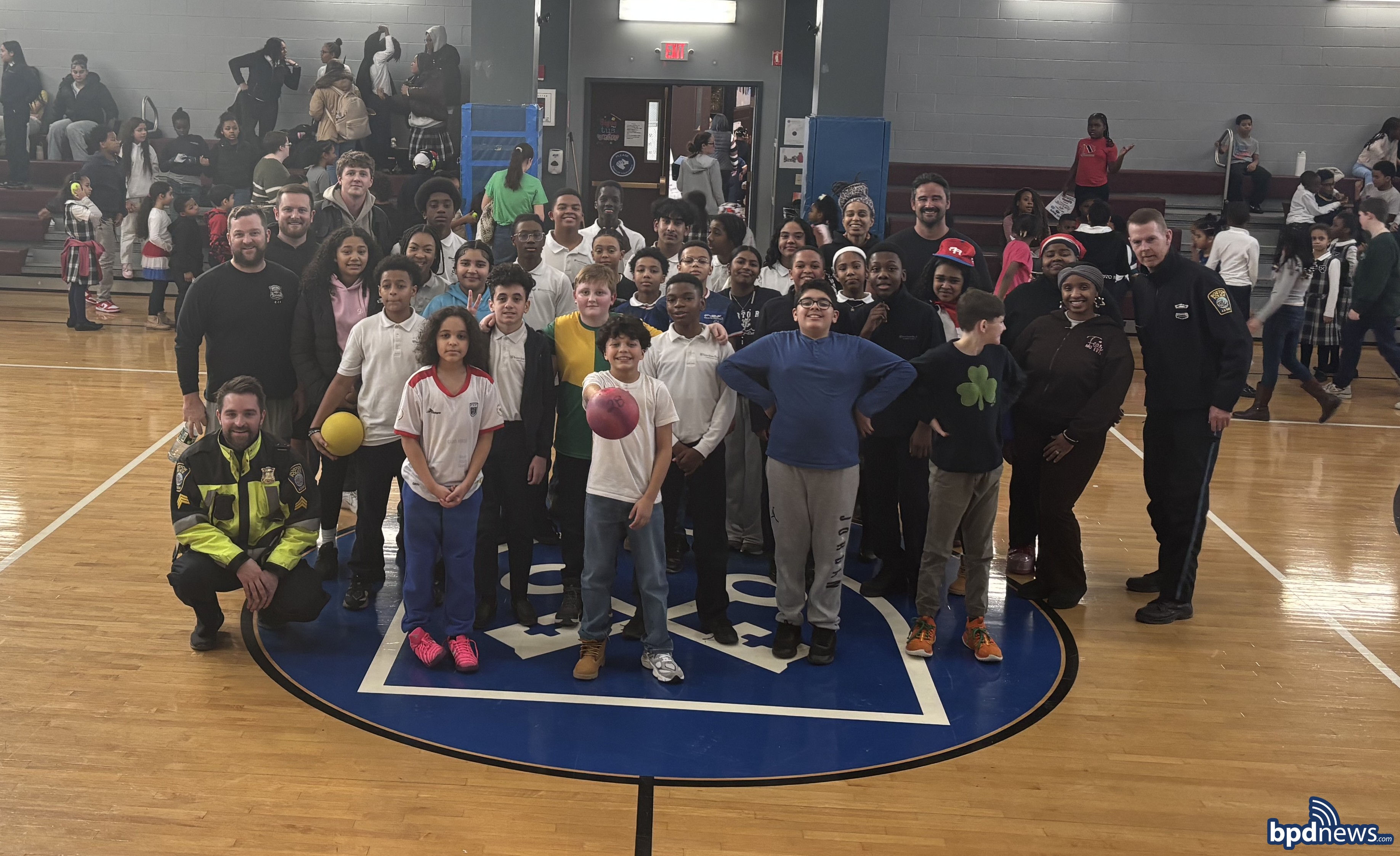 BPD Officers and students from Pope John Paul II Catholic Academy pose for group picture after playing dodgeball together