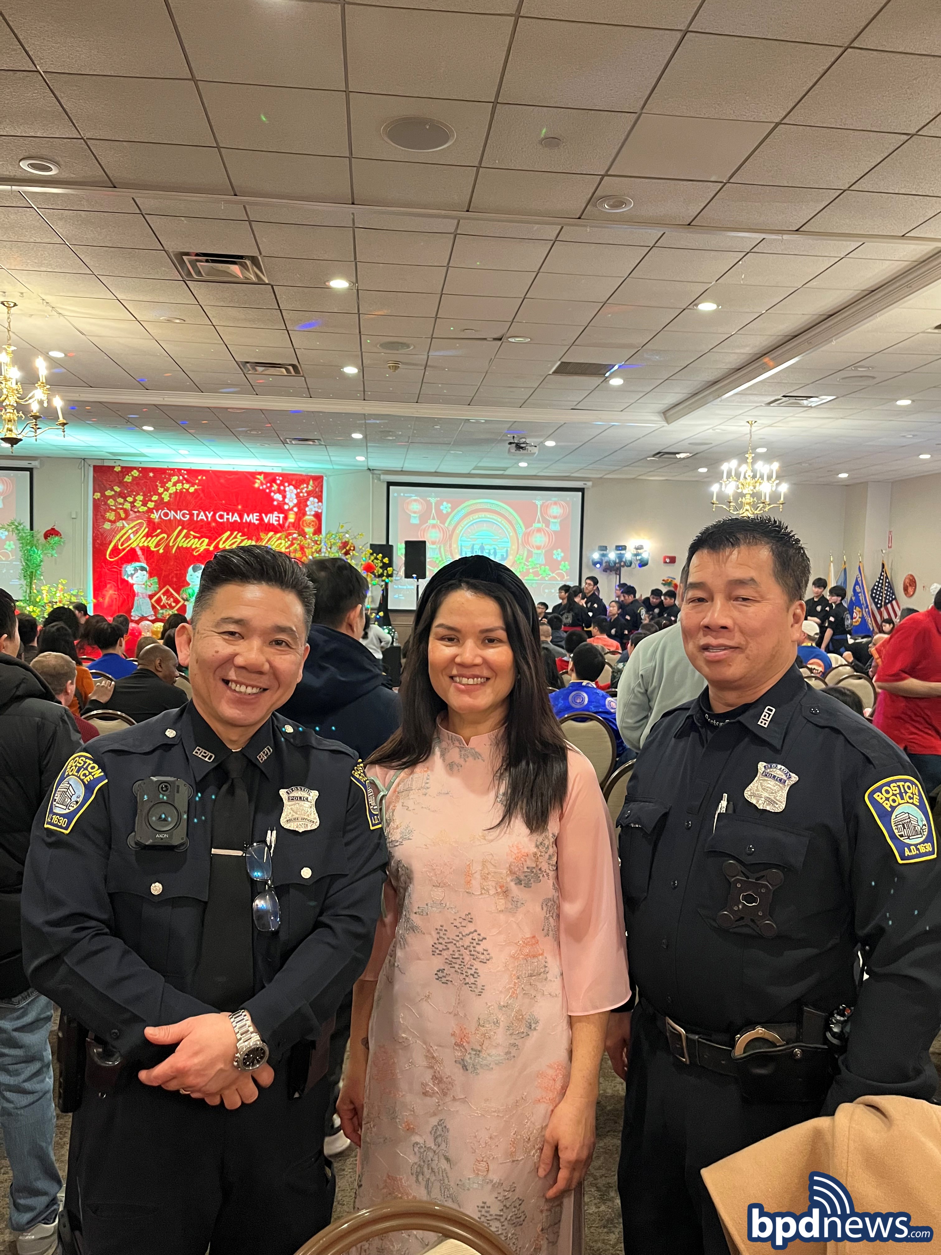 Boston Police Officers pose for photo with a community member