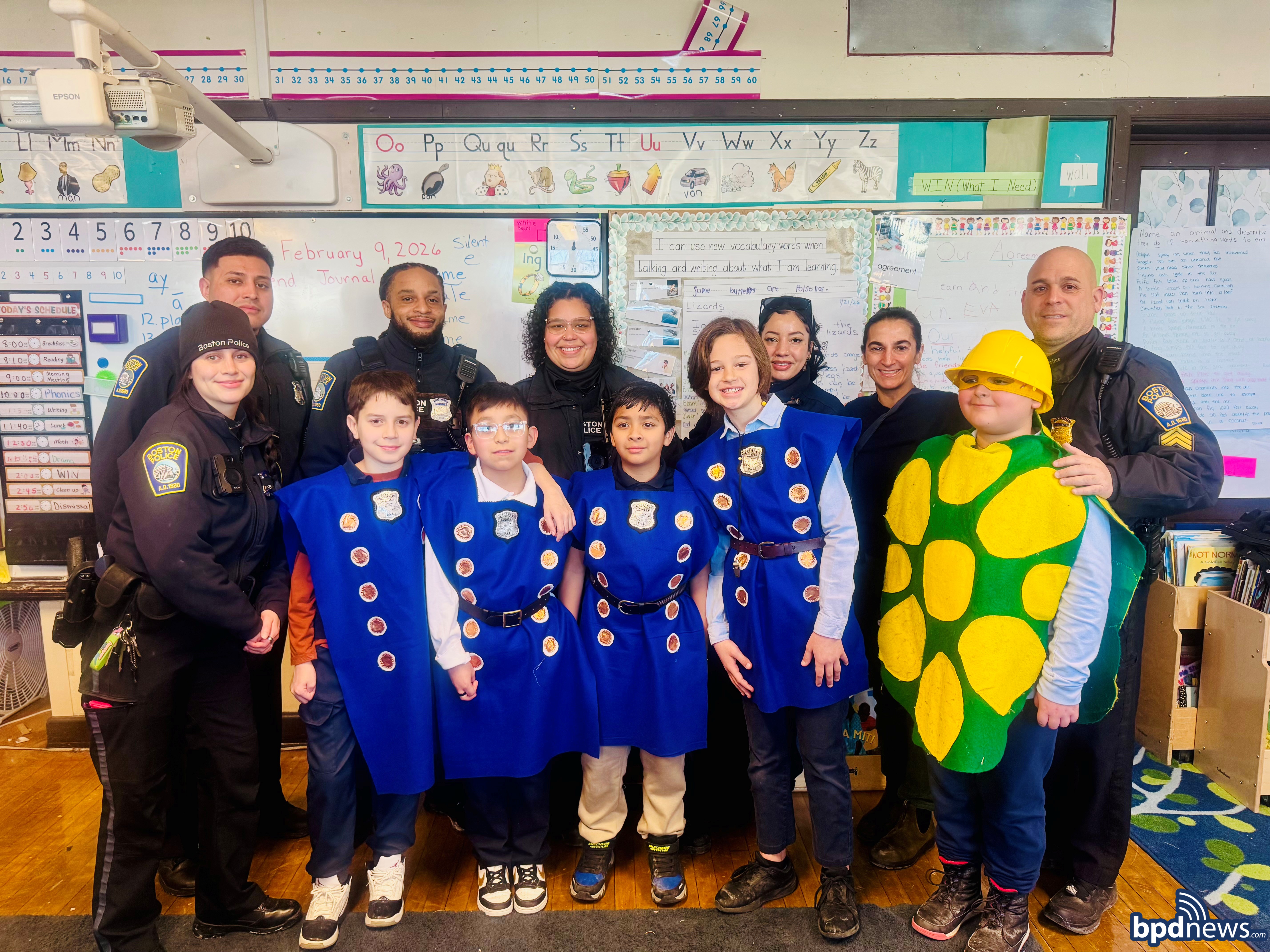 Students, school staff, and BPD officers pose for a group photo