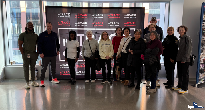 District D-14 Officer poses with Community members at the TRACK New Balance Facility.