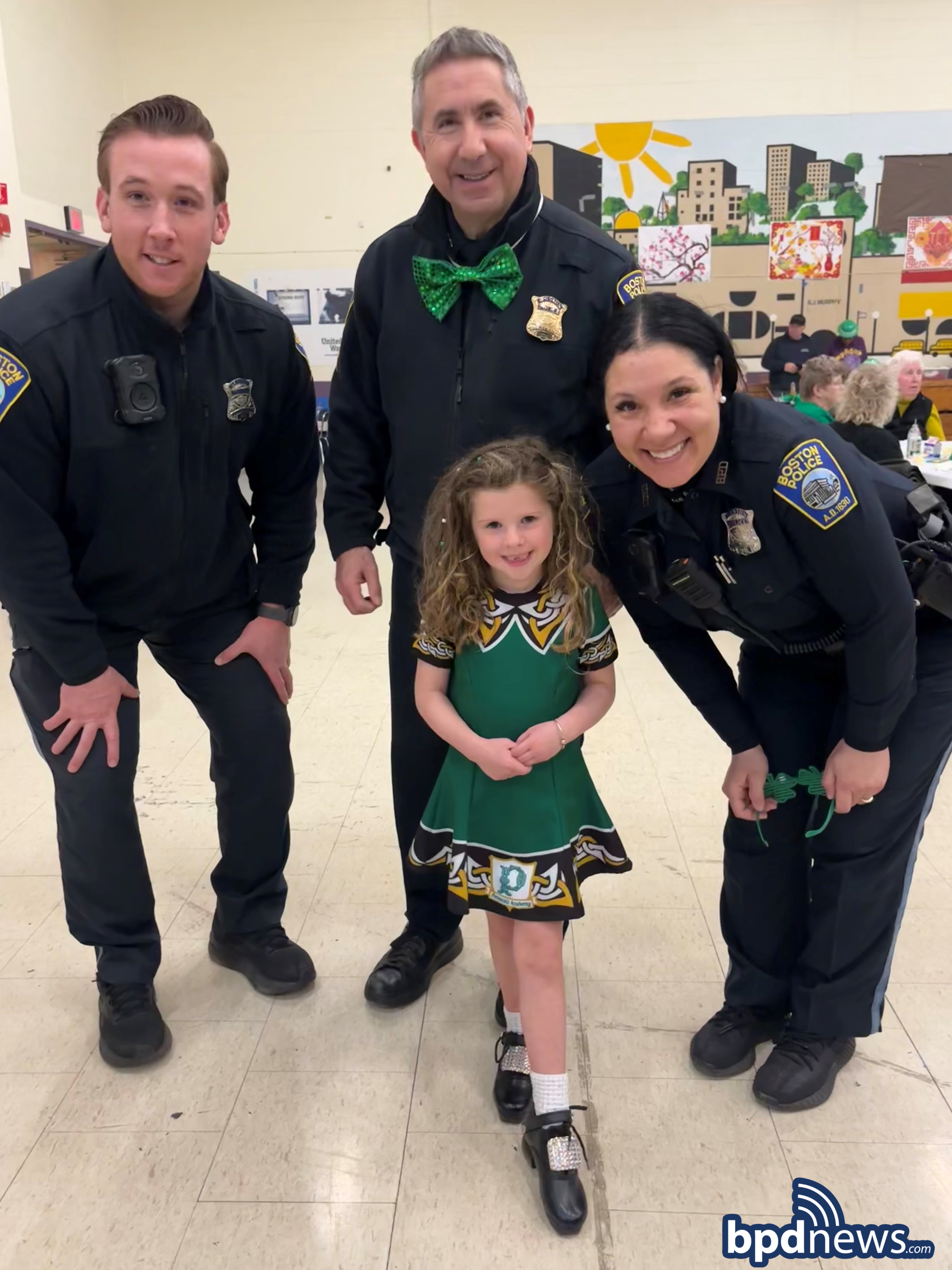 BPD Officers pose for a picture with a young community member